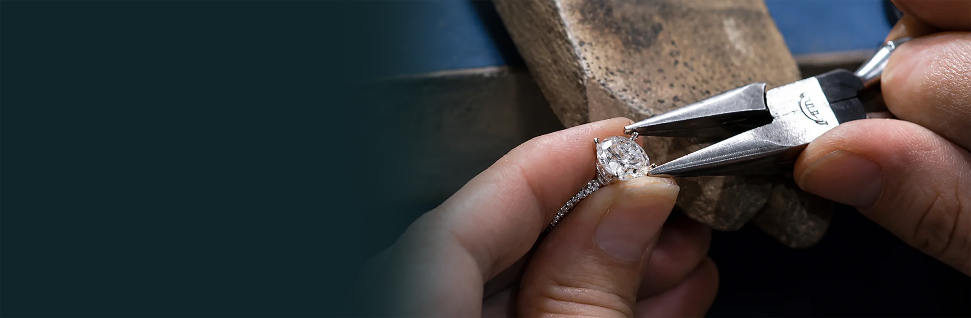 Jeweler setting a gemstone into a ring mount with tweezers