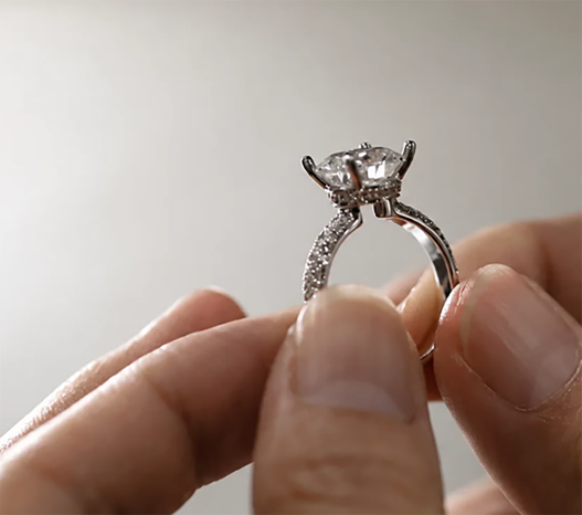 Finished ring held between fingers, checked from the side profile
