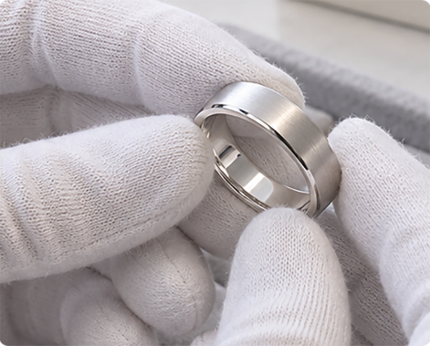 Inspector in white gloves checking a finished ring