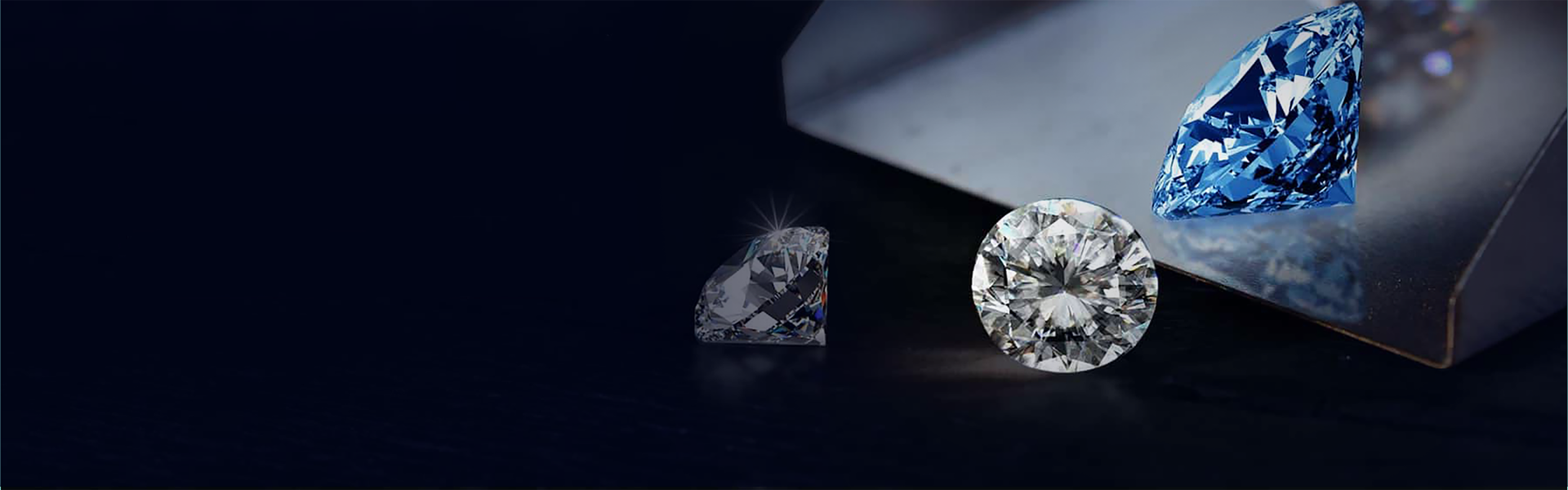 Brilliant cut cubic zirconia stones on a dark reflective surface