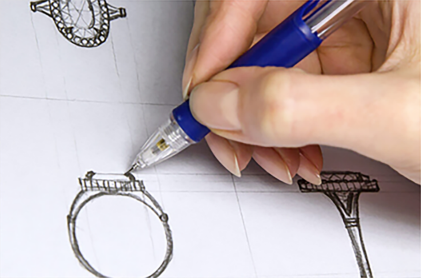 Designer reviewing a bracelet design sketch with a technical pen