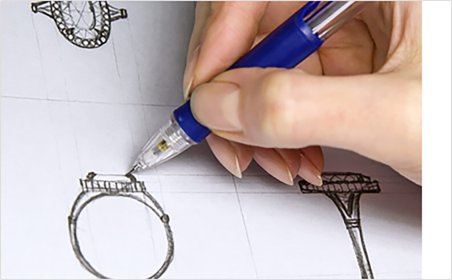 Designer reviewing a custom jewelry brief with drawings