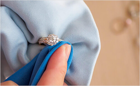 Inspector checking finished custom jewelry under magnification