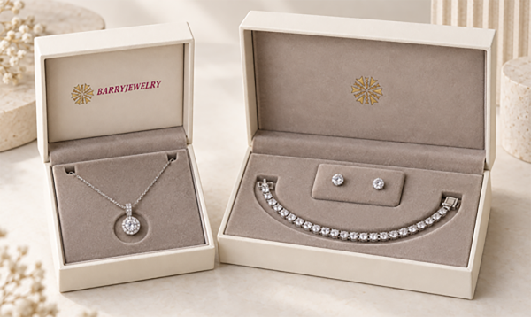 Necklace box and a set box opened to show a pendant necklace, bracelet and earring studs