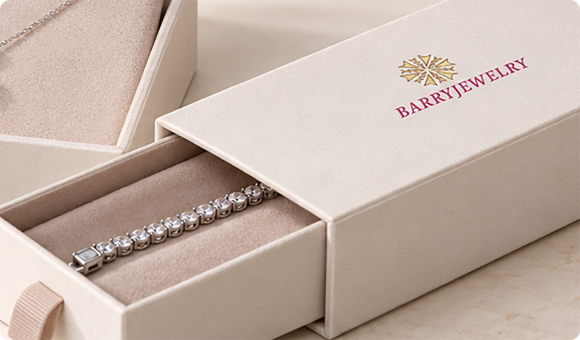Long cream jewelry box opened to show a tennis bracelet resting in its fitted insert