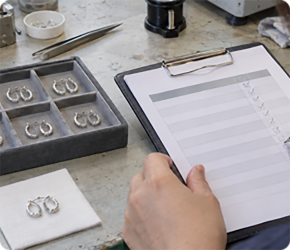 Rings being checked against a written specification on a clipboard