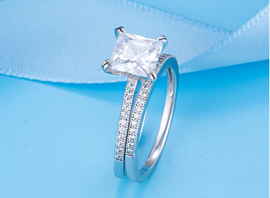 Engagement style ring with a square center stone and pav&eacute; shoulders