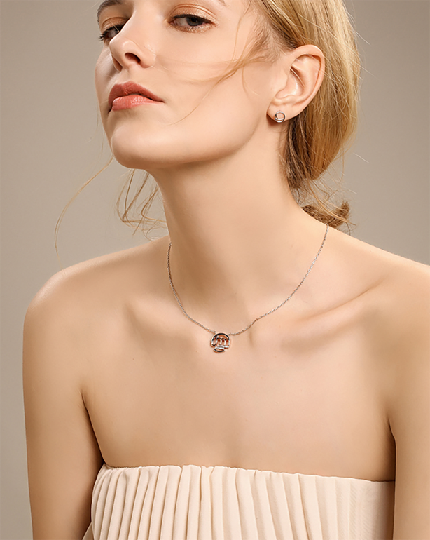 Model wearing a fine pendant necklace with soft studio lighting