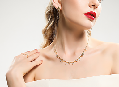 Model wearing a silver chain necklace with a sculptural motif