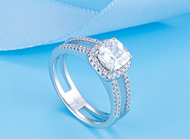 Diamond ring with a pav&eacute; halo presented in a blue box