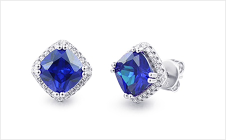 Blue stone stud earrings with a pav&eacute; halo in polished silver