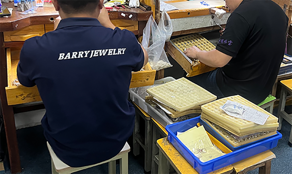 BARRY JEWELRY production team assembling jewelry orders at factory workstations